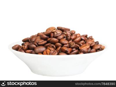 Pile of roasted black coffee beans on plate. Isolated on white background. Close-up. Studio photography.