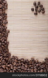 pile of roasted brown coffee beans on bamboo background