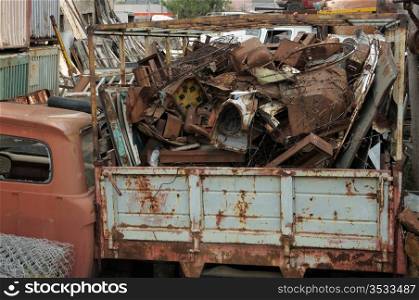 Pile of rusty scrap metal at a junkyard.