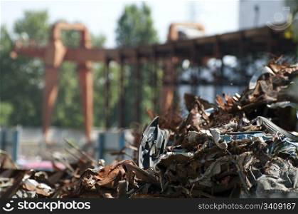 Pile of scrap iron and crane. Blurred background