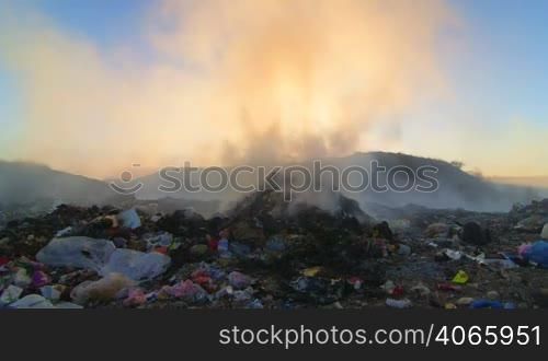 Pile of smoking garbage in the dump site