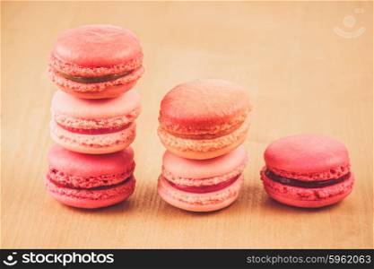 pile of strawberry, raspberry and rhubarb macarons on wooden table