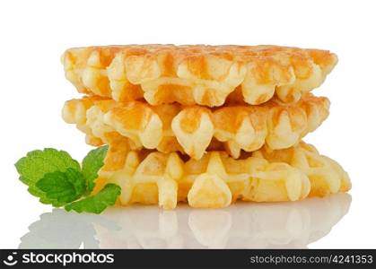 Pile of sweet waffles with green mint leaves isolated on white background.