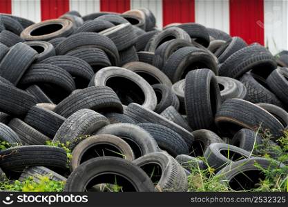 Pile of used tires. Old tyres waste for recycle or for landfill. Black rubber tire of car. Pile of used tires at recycling manufacturing yard. Material for landfill. Pile of second hand tires for sale