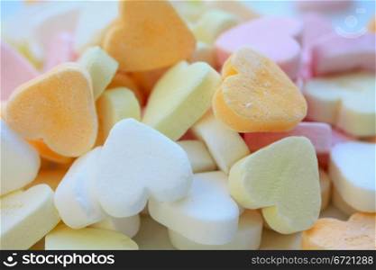 Pile of valentine candy hearts in sweet colors