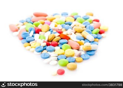 Pile of various colorful pills isolated on white