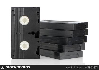 Pile of videotapes on white reflective background.