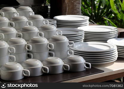 pile of white ceramic cup and plate on table