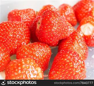 Pile of whole fresh red strawberries without green grass
