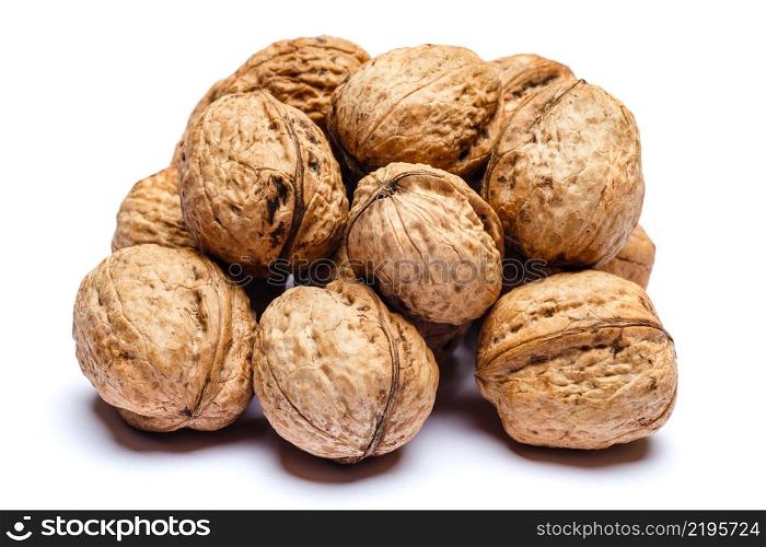 pile of whole walnuts isolated on white background. pile of walnuts isolated on white background
