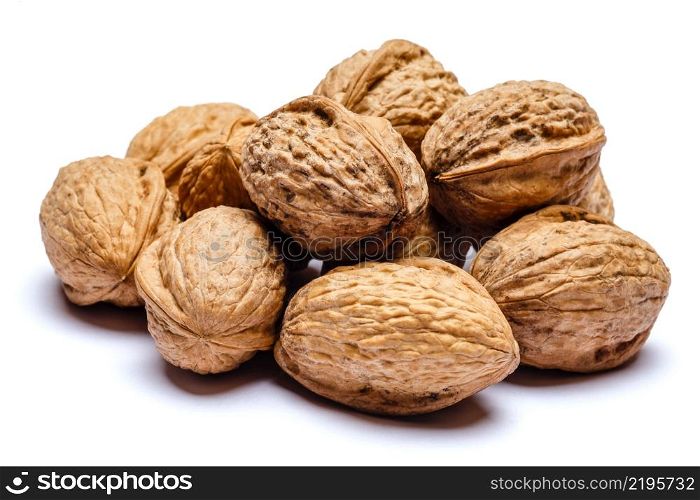 pile of whole walnuts isolated on white background. pile of walnuts isolated on white background