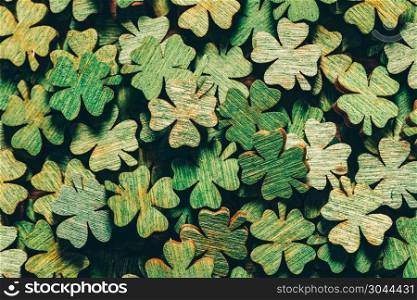 Pile of wooden green four-leaf clovers laying down. Luck symbol. St. Patrick?s day.. Pile of wooden green four-leaf clovers