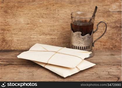 pile parcel wrapped with brown kraft paper and a quill in the inkwell