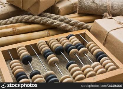 pile parcel wrapped with brown kraft paper and abacus