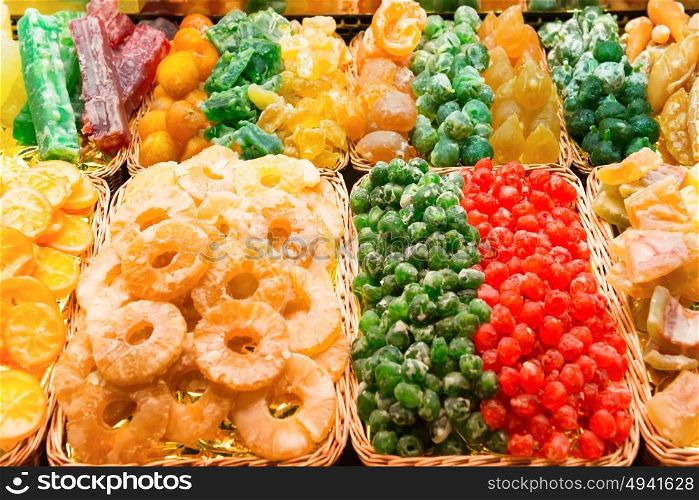 Piles of colorful sweet candy fruits at market