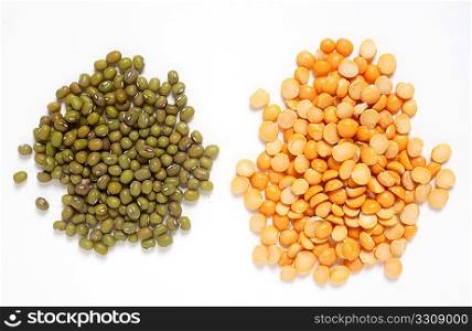 Piles of mung beans (left) and split peas, two common ingredients for asian vegetarian stews (curries).
