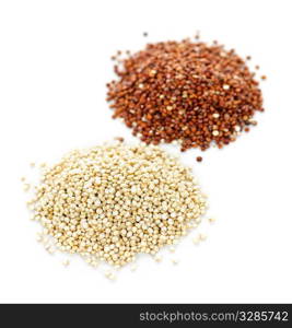 Piles of white and red quinoa grain on white background