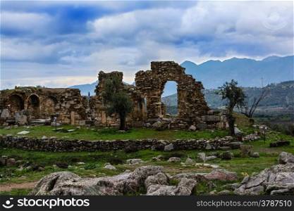Pillar ruins at Ancient Troizina at dramatic sky, Peloponnese, Greece