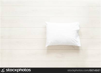pillow in white linen on the wooden floor background. white pillow on the floor