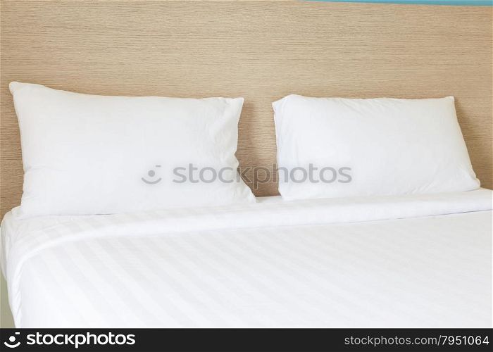 Pillows and bed. White pillows and white bed.