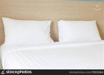 Pillows and bed. White pillows and white bed.