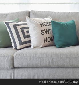 pillows on the cozy grey sofa in living room