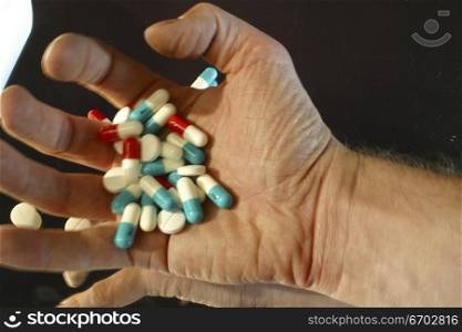 Pills, a colorful handfull of pharmaceutical drugs, Legal drugs, packaging, capsules, suicide atempt.