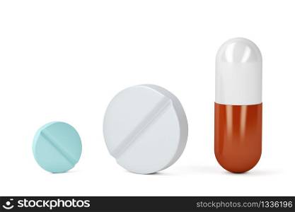 Pills and a capsule on white background