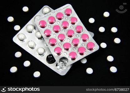 Pills blisters isolated on black background