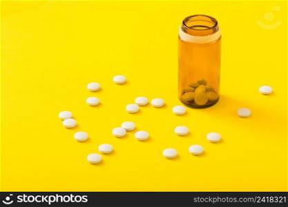 pills bottle circular white medicine yellow background