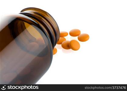 Pills from bottle on the white background.