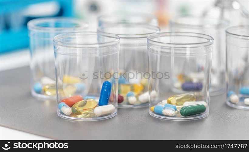 Pills In Disposable Plastic Cup. Medication concept. Pills in a Disposable Plastic Cup