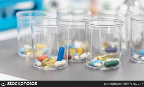 Pills In Disposable Plastic Cup. Medication concept. Pills in a Disposable Plastic Cup