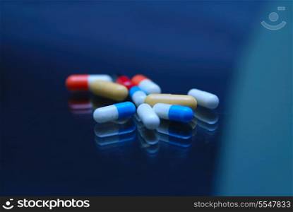 pills on glossy surface with reflection
