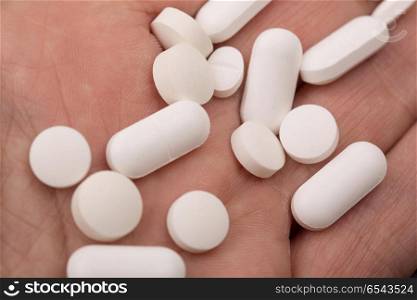 pills on the hand of a man. pills