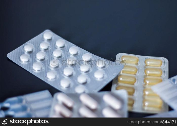 Pills or medicine lying on the grey table, drug abuse