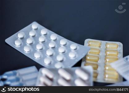 Pills or medicine lying on the grey table, drug abuse