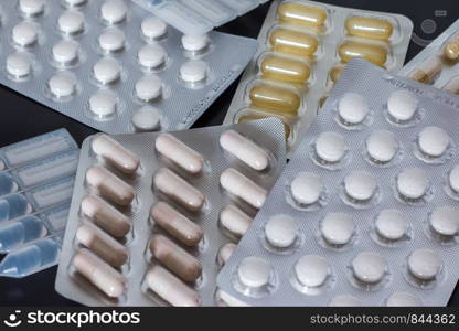 Pills or medicine lying on the grey table, drug abuse