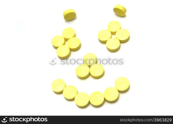Pills smiling face on white background