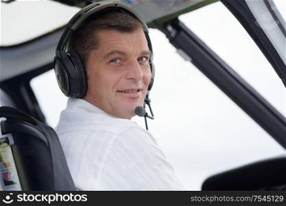 pilot in cockpit of helicopter during flight