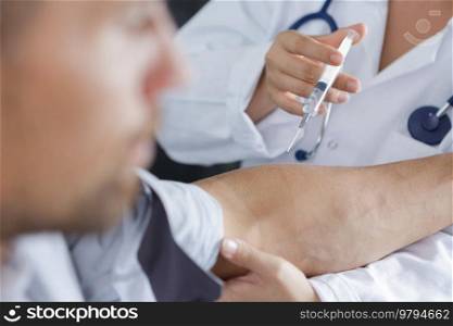 pin in arm syringe pumping blood for test in hospital