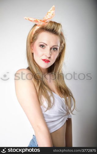 Pin up beautiful blonde girl retro styling, studio shot gray background