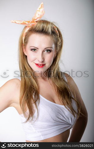 Pin up beautiful blonde girl retro styling, studio shot gray background