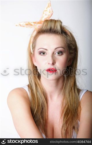 Pin up beautiful blonde girl retro styling, studio shot gray background