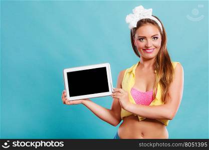 Pin up girl holding tablet computer with blank screen copyspace. Retro woman advertising new modern technology.