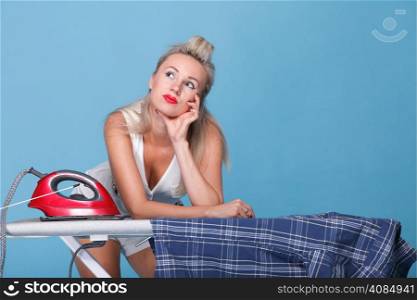 pin up girl retro style portrait woman ironing posing housewife with iron blue background