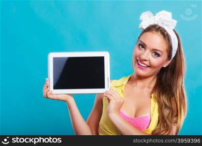 Pin up girl with tablet. Blank screen copyspace.. Happy smiling pin up girl holding tablet computer with blank screen copyspace. Retro woman advertising new modern technology. Old vintage fashion.