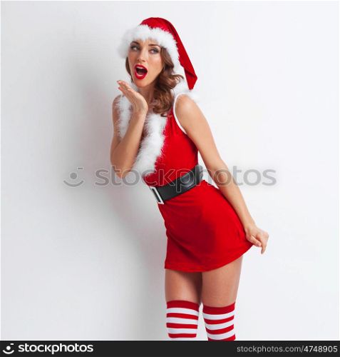 Pin-up Santa girl. Pretty Pin-up style Santa girl in red hat on white background