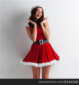 Pin-up Santa girl. Pretty Pin-up style Santa girl in red hat on white background