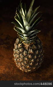 Pine Apple Whole Tropical Fruits with Leaves rusty background Useful Natural Organic Food Style. Close-up.